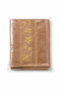 Folded brown baby towel with yellow embroidered stars and patterns, packaged in plastic.