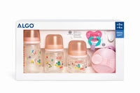 Baby feeding bottle set with pastel pink caps, pacifier, and dispenser in gift box
